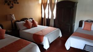 Кровать или кровати в номере Hotel Plaza Copan