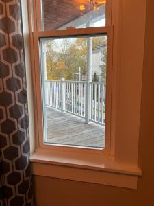 a window with a view of a wooden deck at HomeStay in Boston - Dorchester Fields Corner Area in Boston