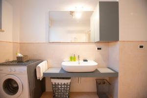 a bathroom with a sink and a washing machine at Casa Adelaide in Senigallia +20 photos