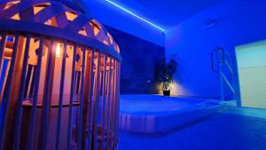 a blue room with a tub with a plant in it at Hotel Butterfly Wellness & Spa in Rimini