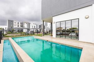 a swimming pool in front of a building at Fredas Place 92 On New in Midrand