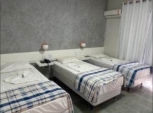 Postel nebo postele na pokoji v ubytování RADAR PÁLACE HOTEL