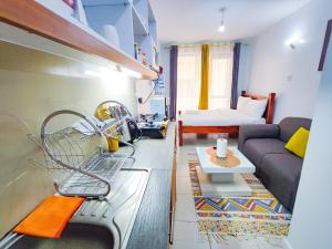 a kitchen and living room with a sink and a couch at Leisure BnB in Kiambu