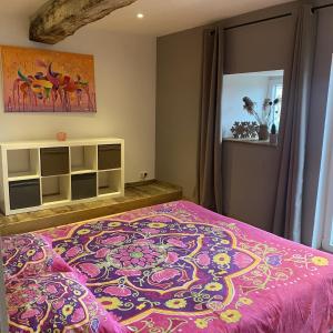 a bedroom with a large bed with a pink blanket at Ferme de Filot 3 in Hamoir +31 photos