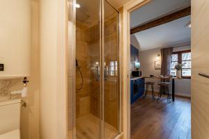 a bathroom with a shower with a glass door at Duplex Caché Toits & Tradition in Sommières +22 photos