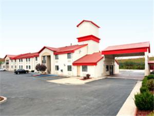 a large building with a parking lot in front of it at Ramada by Wyndham Columbia in Columbia