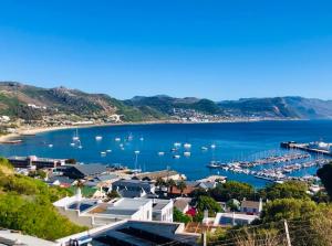 a view of a harbor with boats in the water at Cape Town cottage near colony of penguins in Simonʼs Town
