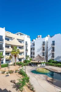 an apartment complex with a swimming pool and buildings at New apartment ready for FUN Cabo dream in Cabo San Lucas