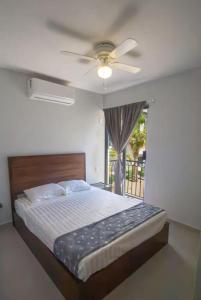 a bedroom with a bed with a ceiling fan at New apartment ready for FUN Cabo dream in Cabo San Lucas