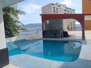 a swimming pool on the roof of a building at Hotel Acuario in Acapulco
