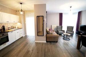 a kitchen and living room with a couch and a table at CCH Elephant Apartments in Poznań