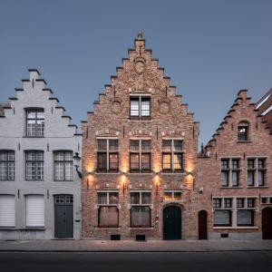 a large brick building with a clock on the front of it at B&B Huis Koning in Bruges