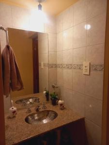a bathroom with a sink and a mirror at Casa Munay in Maimará +78 photos