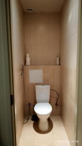 a bathroom with a toilet in a small room at Апартаменты у погранпункта in Narva +11 photos