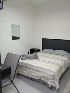 a bedroom with a large bed with a black headboard at ROOMS for rent in Mexico City