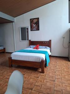 a bedroom with a bed with a red stuffed animal on it at Anchia - Hostel in Alajuela