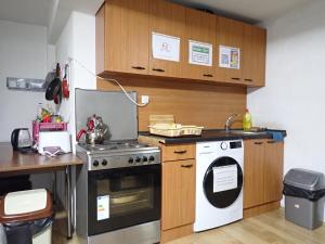 a kitchen with a stove and a dishwasher at Historia Hostel in Skopje