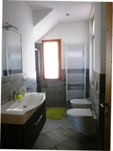 a bathroom with a sink and a toilet and a window at Appartamenti Via Monte Braulio 19 in Bormio +61 photos