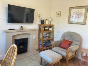 a living room with a fireplace and a tv on the wall at Sunrise, 3 east view in Bamford