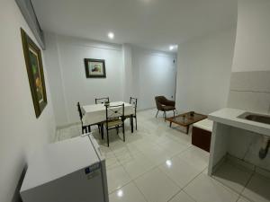 a kitchen and dining room with a table and chairs at Lugar encantador junto al mar in Pacasmayo +11 photos
