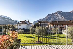 una vista di un edificio con le montagne sullo sfondo di ELVY Garda Living Garden a Riva del Garda