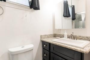 a bathroom with a sink and a toilet at Beautiful Home With Jazucci Tub in New Orleans +25 photos