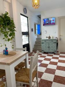 a dining room with a table and chairs and a checkered floor at La Casita del Albayzín in Granada