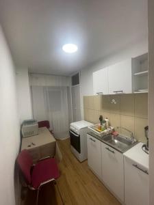 a small kitchen with a sink and a stove at GD House in Bucharest
