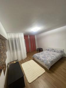 a bedroom with a bed and a table in it at GD House in Bucharest