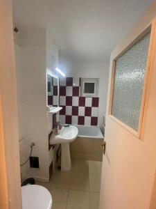 a bathroom with a sink and a toilet and a tub at GD House in Bucharest