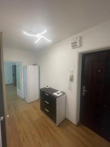 a room with a ceiling fan and a refrigerator at GD House in Bucharest