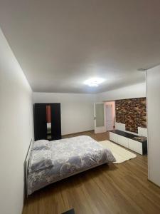 a bedroom with a bed and a brick wall at GD House in Bucharest
