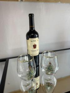 a bottle of wine and two wine glasses on a table at Cedar Street Retreat A Central Downtown in Saint Augustine