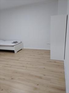 a bedroom with a bed and a wooden floor at Haus Blankenagel 2 in Hagen +1 photo