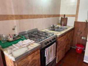 a kitchen with a stove and a sink at Departamento en la costa in Mar del Tuyú