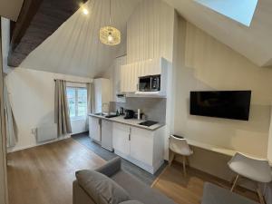 a kitchen with white cabinets and a counter top at Mezza Summer 3ème Étage in Abbeville