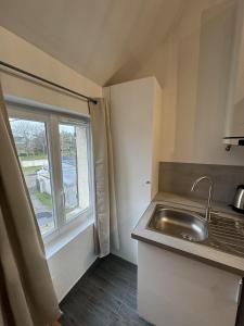 a small kitchen with a sink and a window at Mezza Summer 3ème Étage in Abbeville +35 photos