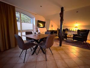 a table and chairs in a living room with a fireplace at Schwarzwaldhimmel in Feldberg