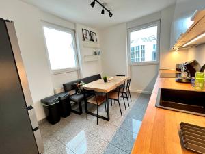 a kitchen with a table and chairs in a room at LTA Apartment München Süd No2 Relax & Chill in Munich