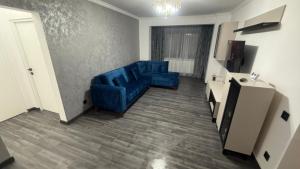 a living room with two blue chairs in a room at Ama Residence in Brăila