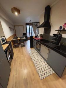 a kitchen with a stove and a counter top at Appartements bien situés avec terrasse in Le Mont-Dore +13 photos