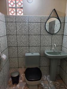 a bathroom with a toilet and a sink at Hostel X DE CARAIVA in Caraíva +27 photos