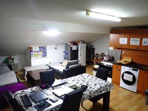 a kitchen and living room with a table and a kitchen and a room with at Historia Hostel in Skopje