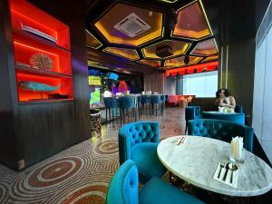 a dining room with a table and blue chairs at The Suites At Platinum KLCC in Kuala Lumpur
