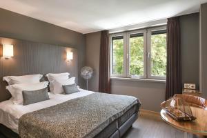 מיטה או מיטות בחדר ב-B&B Huis Koning