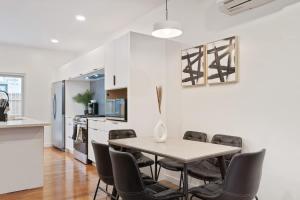 a kitchen and dining room with a table and chairs at 3 BDRM 2 and a Half Bath - House Private Yard Duplex in Pittsburgh