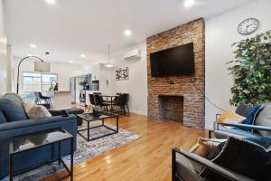 a living room with a fireplace and a tv at 3 BDRM 2 and a Half Bath - House Private Yard Duplex in Pittsburgh
