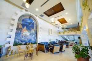 a lobby with a large painting on the wall at Bethlehem Hotel in Bethlehem