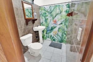a bathroom with a toilet and a shower at Drift Inn Cayo in Santa Elena +45 photos