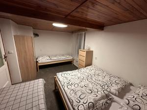 a room with two beds and a dresser in it at Chata Slunečná louka in Cerny Dul